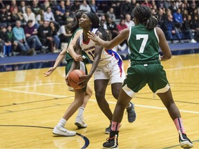 Semiahmoo Totems' Deja Lee takes the ball to the basket as Walnut Grove's Fania Taylor (7) blocks in the girls basketball final at Langley Events Centre in the 2019 high school basketball provincials. This year's tournaments are in jeopardy after hte Ministry of Education opted to keep sports tournaments on the backburner.