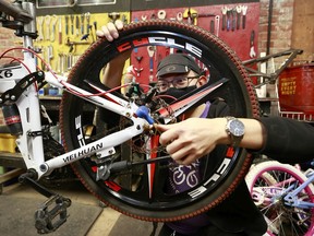 Cavan Hua dismantles a broken bike at Our Community Bikes January 29, 2022 in Vancouver.