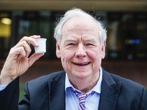 Calvin Sandborn holds up one of Keurig Canadas plastic coffee pods.