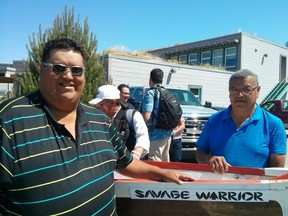 Kelly and Johnny Louis are Musqueam Nation canoe-builders, here seen with the Savage Warrior canoe that they restored that was built by Dominic Point and is on display in the Musqueam Community building.