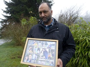Upkar Tatlay holds a collage containing photos of various family members in White Rock on Feb. 10.