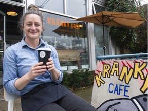 Tondela Myles holds a reusable coffee cup outside her Kranky's cafe in Vancouver on Feb. 28.