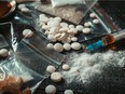 Feb. 16, 2022 - Hard drugs on dark table. Drug syringe and cooked heroin - stock photo