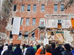 A crowd in Alert Bay watches the demolition of St. Michael's Indian Residential School in 2015.