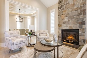 Elegant furniture sets the scene next to a cozy gas fireplace in the living room.