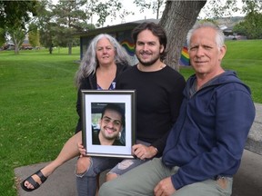 Levi Manson holds a photo of his late brother, Aaron, joined by mom Troylana and dad Bart. This photo was taken in September 2021 at Prince Charles Park in downtown Kamloops.