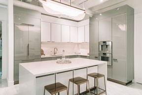 The display suite kitchen showcases a waterfall island as well as the dual-toned kitchen-cabinet design.