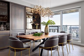 A Terzani Argent chandelier emulates starry skies – a tribute to the condo's sky-scraping altitude – while a live-edge walnut dining table and velvet Rove Concepts chairs give modern glam appeal.
