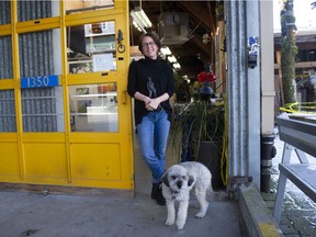 Lynn Falconer, a sculptor and president of the Granville Island Business and Community Association, with her dog Chico in front of her studio on Feb. 24, 2022. Photo: Mike Bell/PNG