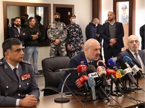 Lebanon's Interior Minister Bassam Mawlawi (C) speaks during a press conference alongside the head of Internal Security Forces (ISF) Imad Osman (L) and Head of ISF Information Branch Khaled Hammoud, in the capital Beirut, on February 23, 2022, to announce thwarting planned attacks by the Islamic State (IS) group.