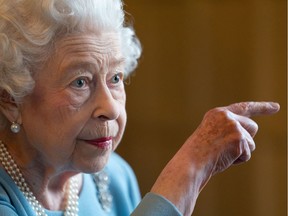 Britain's Queen Elizabeth II gestures during a reception in the Ballroom of Sandringham House, the Queen's Norfolk residence on February 5, 2022.