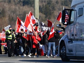 Anti-vaccine mandate protesters demonstrate on Highway 15 near the Pacific Highway Border Crossing on the US-Canada border with Washington State in Surrey, British Columbia, Canada on February 12, 2022.