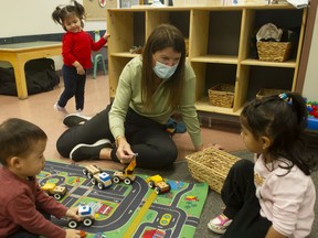 Sharon Gregson, spokesperson for the $10 A Day Child Care Campaign, plays with children at the Collingwood Neighbourhood House's toddler program in Vancouver on Feb. 17, 2022.