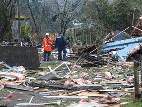 Crews scour over the scene of a home which exploded on Pine Street (at the corner of Fitzwilliam street), located beside the cemetery at St. Peter's Roman Catholic Church in Nanaimo. Victoria on Feb. 28, 2022.
