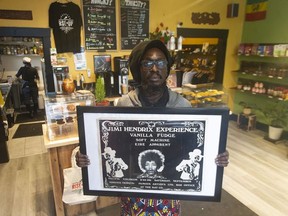 Roger Collins from Rise Up Marketplace with a vintage Jimi Hendrix concert poster from 1968.