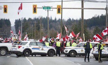 Vancouver, BC: FEBRUARY 19, 2022 -- Hundreds of people protest mask and vaccine mandates at 176th and 8th Avenue in Surrey, BC Saturday, February 19, 2022. The Pacific Highway border crossing was closed by police due to the size of the protest. 



(Photo by Jason Payne/ PNG)

(For story by Nathan Griffiths) ORG XMIT: freedomconvoy [PNG Merlin Archive]