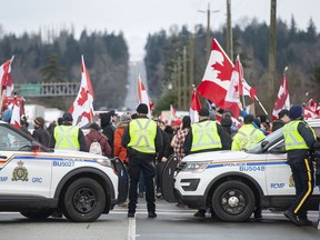 Hundreds of people protest mask and vaccine mandates at 176th and 8th Avenue in Surrey, BC Saturday, February 19, 2022. The Pacific Highway border crossing was closed by police due to the size of the protest. Jason Payne/PNG