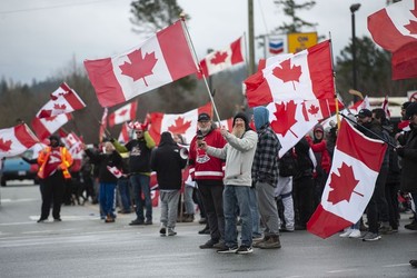Hundreds of people protest mask and vaccine mandates at 176th and 8th Avenue in Surrey, B.C., Saturday, Feb. 19, 2022. The Pacific Highway border crossing was closed by police due to the size of the protest.