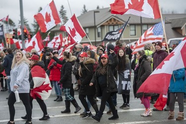 Hundreds of people protest mask and vaccine mandates at 176th and 8th Avenue in Surrey, B.C., Saturday, Feb. 19, 2022. The Pacific Highway border crossing was closed by police due to the size of the protest.