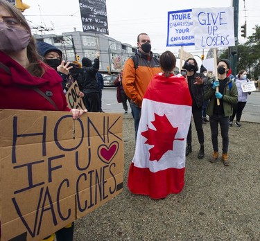 Vancouver, BC: FEBRUARY 19, 2022 -- Several dozen anti vaccine mandate protestors, marshalling for a 'freedom rally', are met by an equal number of counter protestors at E. Hastings and Renfrew Streets Saturday morning, February 19, 2022. The police eventually stepped in to keep the groups separate as the convoy left.



(Photo by Jason Payne/ PNG)

(For story by Nathan Griffiths) ORG XMIT: freedomconvoy [PNG Merlin Archive]