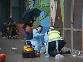 Paramedics help a man suffering a drug overdose on Columbia Street in Vancouver's Downtown Eastside in May 2020. (Jason Payne/PNG)