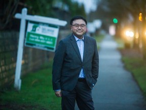 SFU researcher Andy Yan stands along East Broadway in Vancouver.