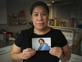 Naneek Graham with photo of her father John, who says, "I wasn't even in South Dakota when this crime happened. I keep telling them over and over. It's a manufactured case. It's a fraudulent case."