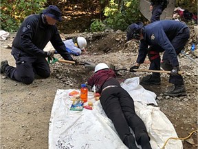 Individuals in blocking devices lying on the ground at Fairy Creek Watershed in 2021.