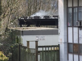 Smoke still smoulders on the roof after a fire engulfed a storage shed on PNE grounds in Vancouver, BC, February 20, 2022.