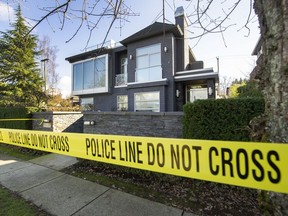 Police tape off an area around a house on West 8th Avenue and Discovery Street in Vancouver's Point Grey neighbourhood on Feb. 20, 2022.