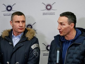 Brothers Wladimir (left) and Vitali Klitschko, both former world heavyweight champions, talk to journalists early this month in Kyiv, at a Ukrainian Territorial Defence Forces recruitment centre, three weeks before the Russian bombs started dropping on Ukraine.