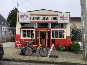 The Rise Up Marketplace at 704 Vernon Drive in Vancouver on Feb. 9, 2022. The store used to be known as the Vernon Drive Grocery, and kept the old sign in a nod to its past. It has been a grocery since 1914. Note the picket fence painted in the colours of the “African Caribbean diaspora” on the door.