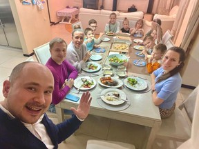 The night before Russia invaded Ukraine it was life as usual. Sergii Bielousov took this selfie of his family and friends having dinner on Wednesday, Feb. 23.