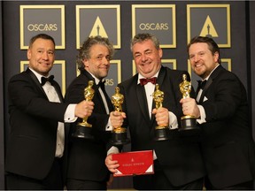 The Dune team of (left to right) Tristan Myles, Brian Connor, Paul Lambert, Gerd Nefzer, winners of the Visual Effects award for Dune pose in the press room during the 94th Annual Academy Awards.