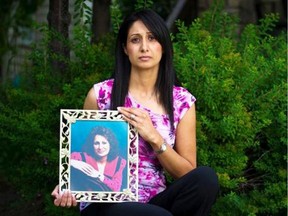 Rupy Sidhu holds a photo of her mother outside her Alberta home.