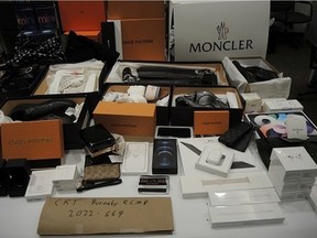 Burnaby RCMP said it has seized $30,000 worth of stolen luxury goods following an investigation into the theft of cell phones from a Metrotown business. The handout photos show a selection of a nearly 100 items seized including jewelry, high-end clothing and electronics.