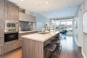 Functional kitchen island offers double duty for cooking and entertaining at this Vancouver condo.