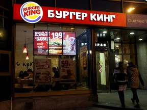 Women walk outside a Burger King restaurant in Moscow, September 15, 2015.