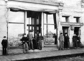 Exterior of the CPR. offices, 640-650 Granville St. in the New York Block, 1892. Men identified, from left Jimmy Black, EJ Coyle, Sir George McLaren Brown, John Virtue, Charles Millard, Jim Loutit, Harry Johnson, Frank Marten and a messenger boy .