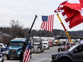 Hundreds of vehicles including 18-wheeler trucks, RVs and other cars depart the Hagerstown Speedway after some of them arrived as part of a convoy that travelled across the U.S. and headed to Washington, D.C. to protest COVID-19 related mandates and other issues in Hagerstown, Maryland, Sunday, March 6, 2022.