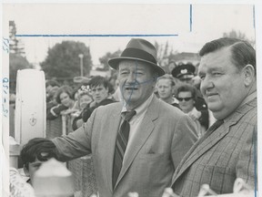 Former Vancouver Sun photographer Harry Filion (right) with movie star John Wayne in 1969. An editor has written an "X" over Wayne's face so he can be cropped out of the photo for the paper. Brian Kent/Vancouver Sun archives