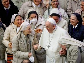 Pope Francis greets nuns after the weekly general audience at the Paul VI Audience Hall at the Vatican, January 19, 2022.