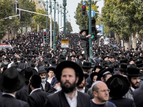 Ultra-Orthodox Jewish mourners gather to attend the funeral of Haredi rabbi Chaim Kanievsky in the Israeli city of Bnei Brak near Tel Aviv, on March 20, 2022.
