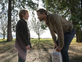 Walker Scobell as Young Adam and Ryan Reynolds as Big Adam in Netflix feature The Adam Project.