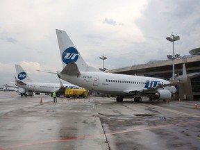 Boeing Co. 737-500 passenger jets operated by UTAir Aviation stand at their terminal positions at Vnukovo airport in Moscow, Russia, on Wednesday, Aug. 6, 2014.