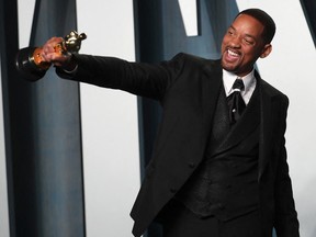 Will Smith poses with his Oscar as he arrives at the Vanity Fair Oscar party during the 94th Academy Awards in Beverly Hills March 27, 2022.