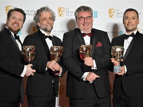 Visual effects artists (L-R) Tristan Myles, Paul Lambert, Gerd Nefzer and Brian Connor pose with their awards for Special Visual Effects for their work on the film Dune at the BAFTA British Academy Film Awards at the Royal Albert Hall in London on March 13, 2022.