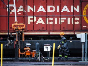 File photo of CP Rail workers. The Langley Bypass will be closed for 24 hours while crews repair the rail crossing.