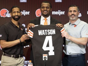 Quarterback Deshaun Watson, flanked by Cleveland Browns general manager Andrew Berry (left) and head coach Kevin Stefanski (right), at news conference announcing he had joined the National Football League club on Friday in Berea, Ohio.