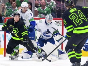Vancouver Canucks defenceman Luke Schenn checks Dallas Stars left wing Jason Robertson from behind during the first period at the American Airlines Center March 26.